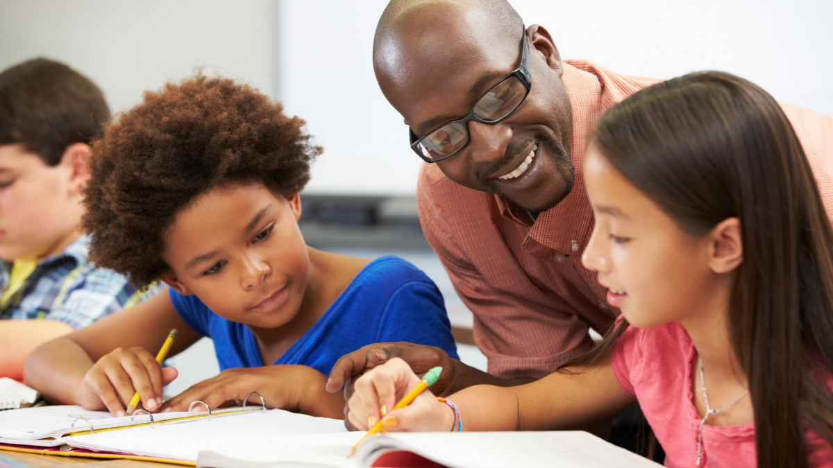 Man teaching children education in a class room