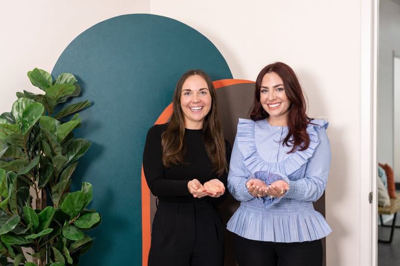 Two smiling women, symbolizing the idea of Give to gain.