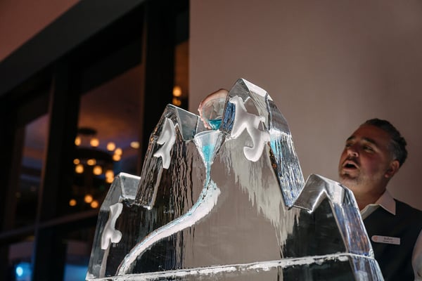 Bartender pouring a drink into an ice sculpture