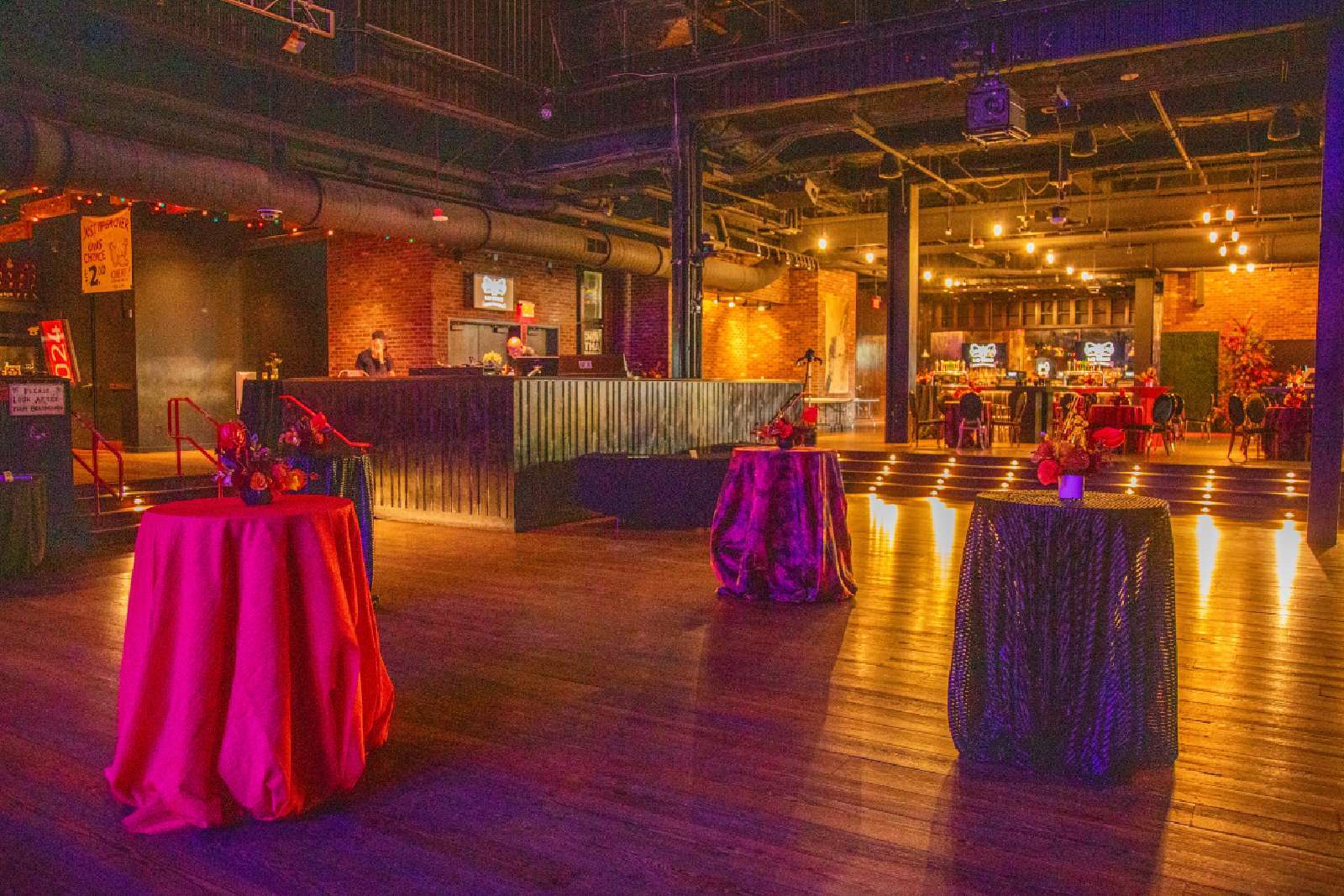 fancy room with warm light and colorful blankets over tables