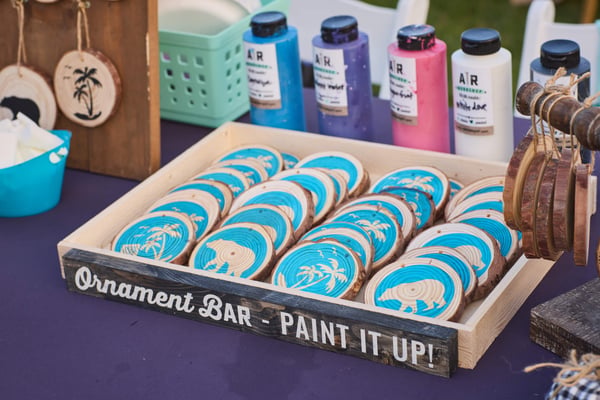 Close-up of a craft station with cookies and paint supplies