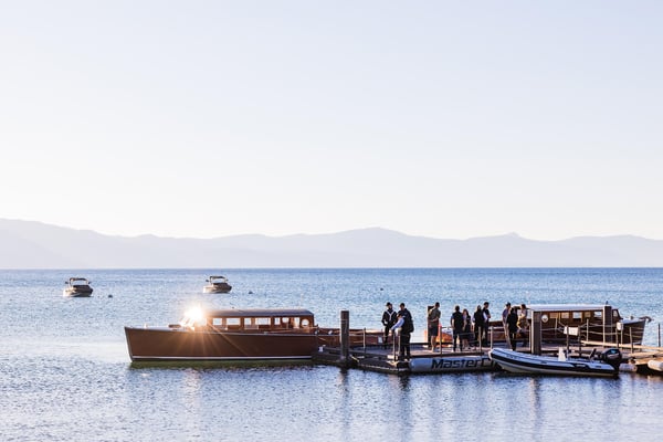 Guests boarding a vintage boat at the dock. 