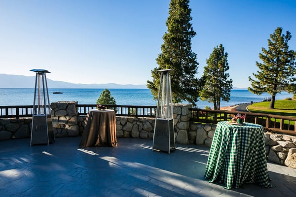 Cocktail tables on a lakeside terrace. 