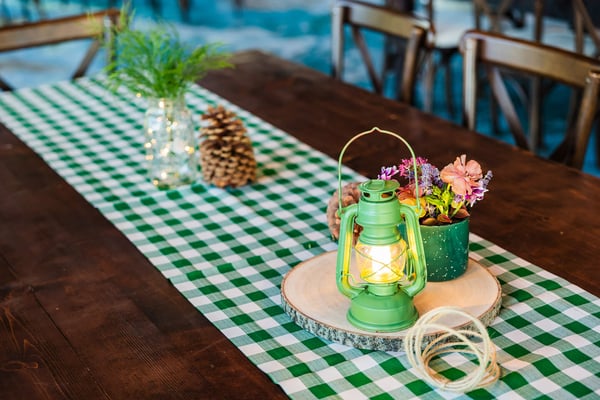 Rustic centerpiece with lantern and wildflowers.