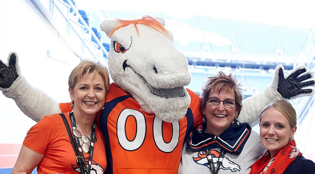 women with football team's pet
