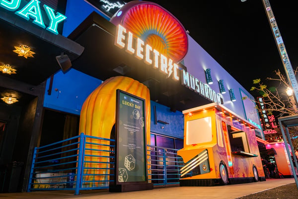 Neon-lit venue exterior at night. 