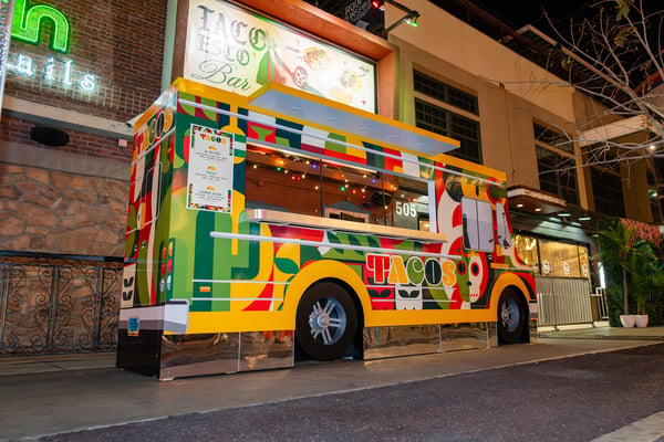 Colorfully branded food truck at night. 