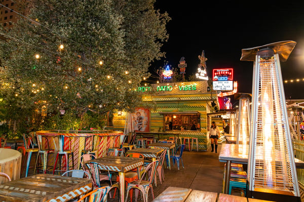 Outdoor lounge and dining area with string lights. 