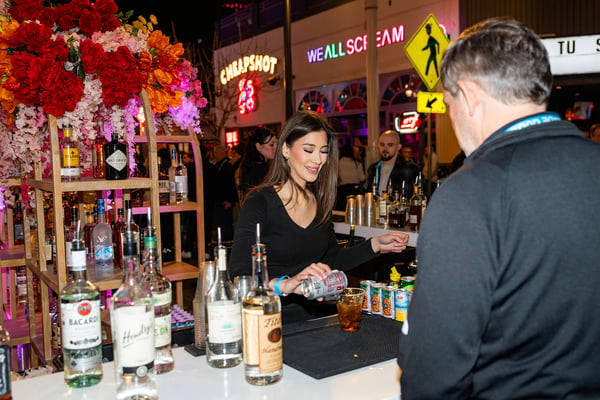 Bartender serving guests at an outdoor event. 