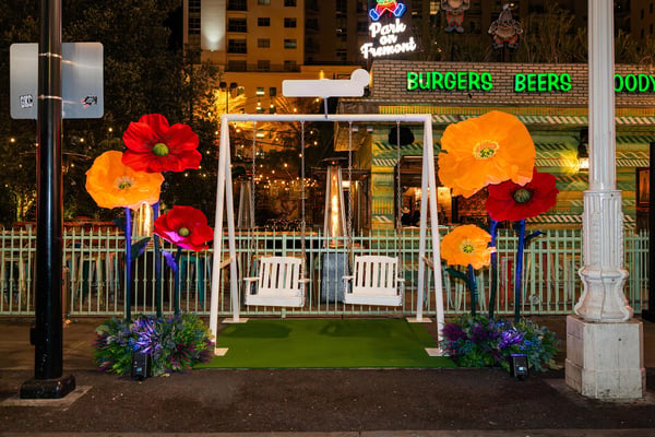 Floral entrance display at a nighttime event.