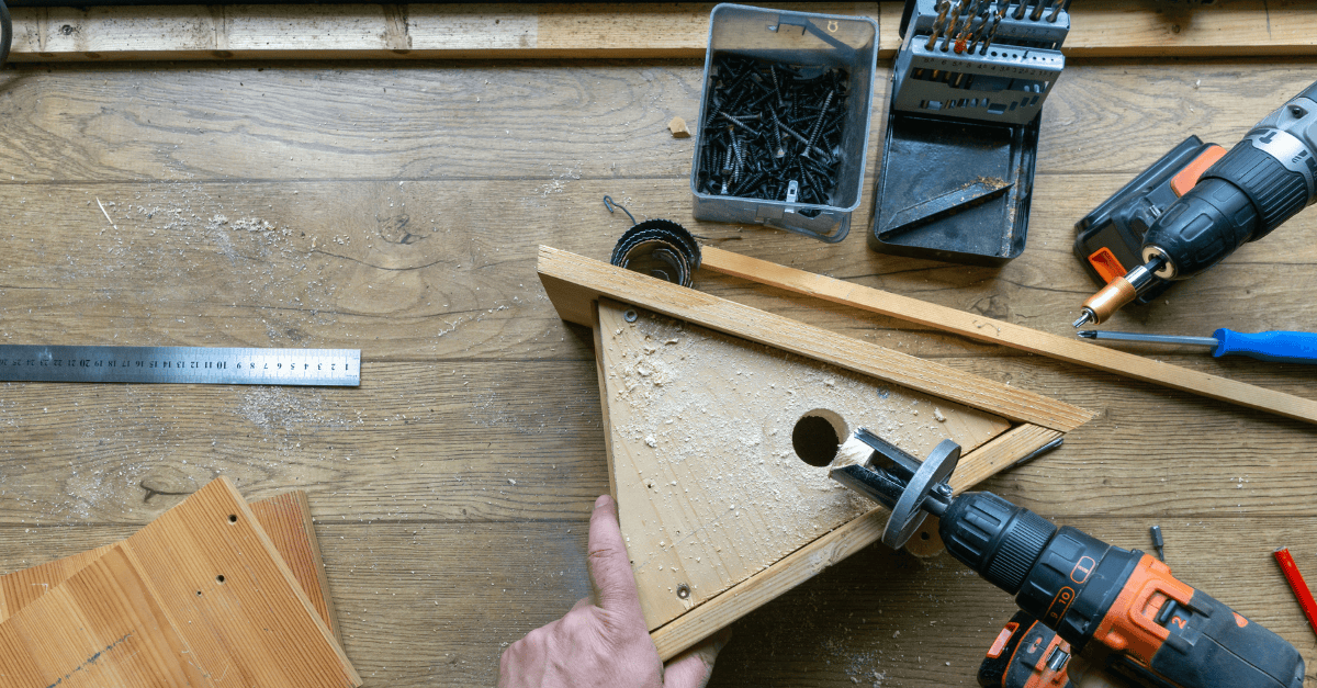 Birdhouse being built with power tools.