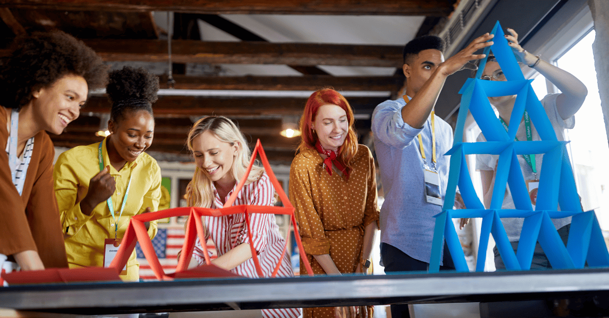 Team builds colorful structures together.