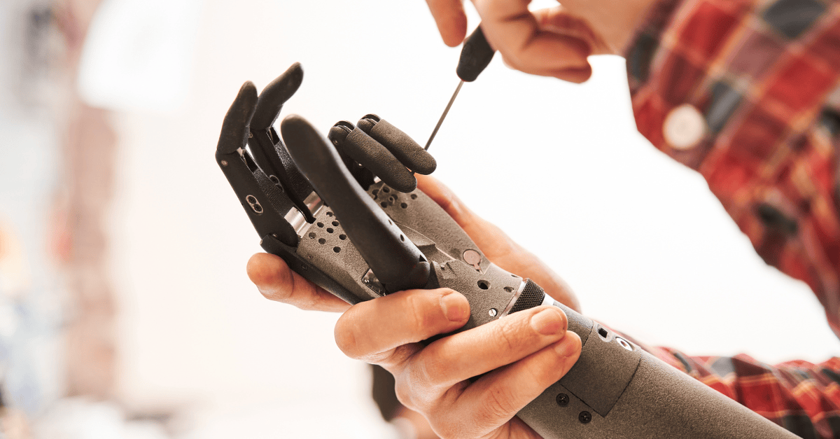 Technician adjusts a robotic prosthetic hand.