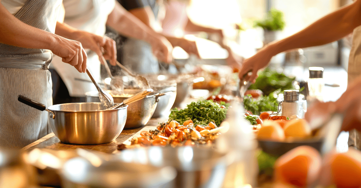 Volunteers prepare a meal with fresh ingredients.