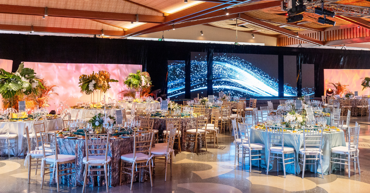 Elegant banquet setup with a large digital stage.