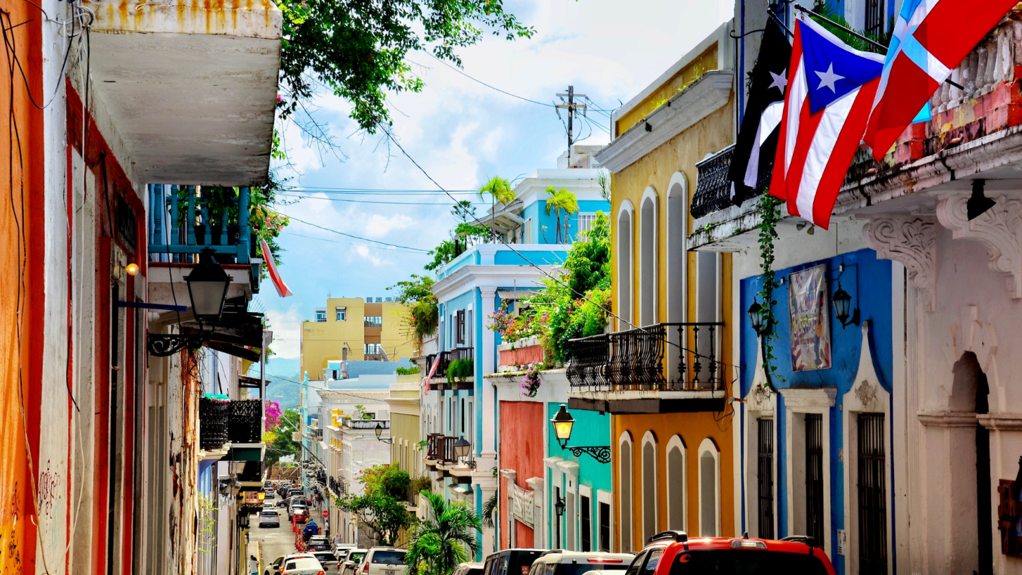Colorful Old San Juan street with Puerto Rican flags.