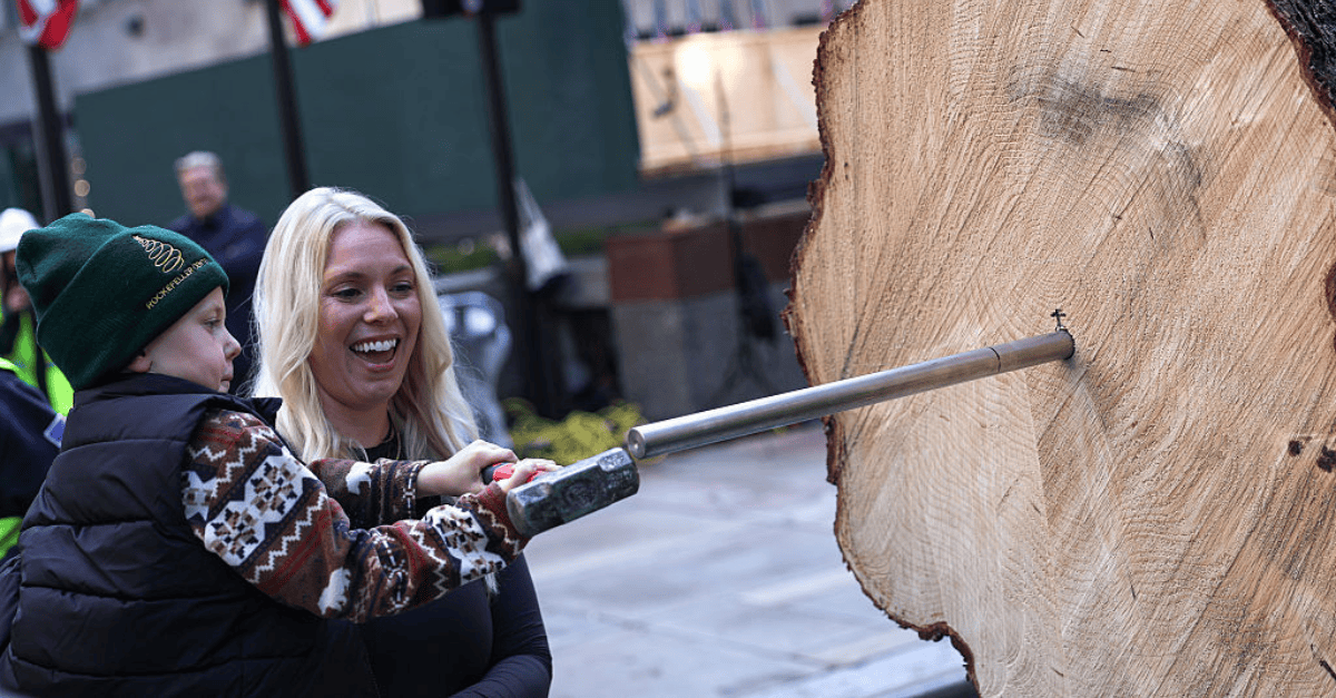 A child helps prepare the Rockefeller Center Christmas tree.