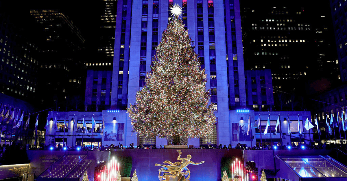 Illuminated Rockefeller Center Christmas tree at night.
