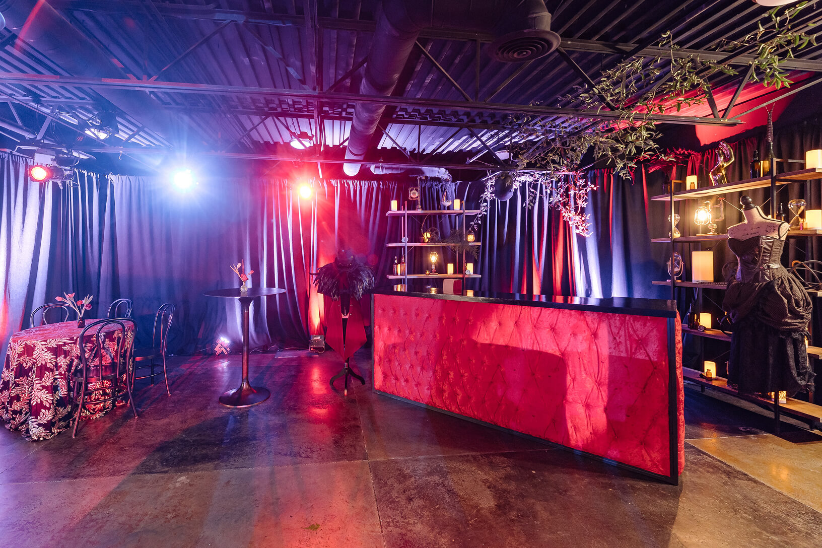 Red-lit event bar with dramatic décor and vintage accents.