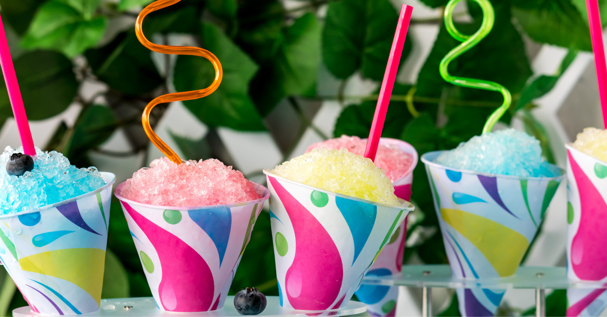 Colorful shaved ice drinks with curly straws.