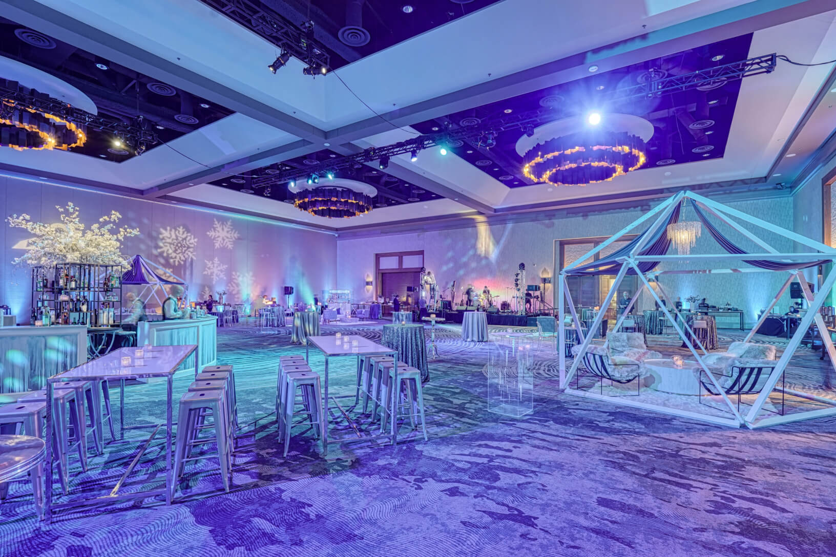 Wide shot of a winter-themed event space with lounge areas