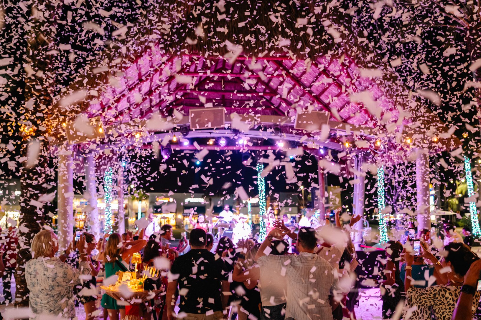 A shower of white confetti fills the outdoor pavilion as guests celebrate the finale of the Maritz Activate block party.